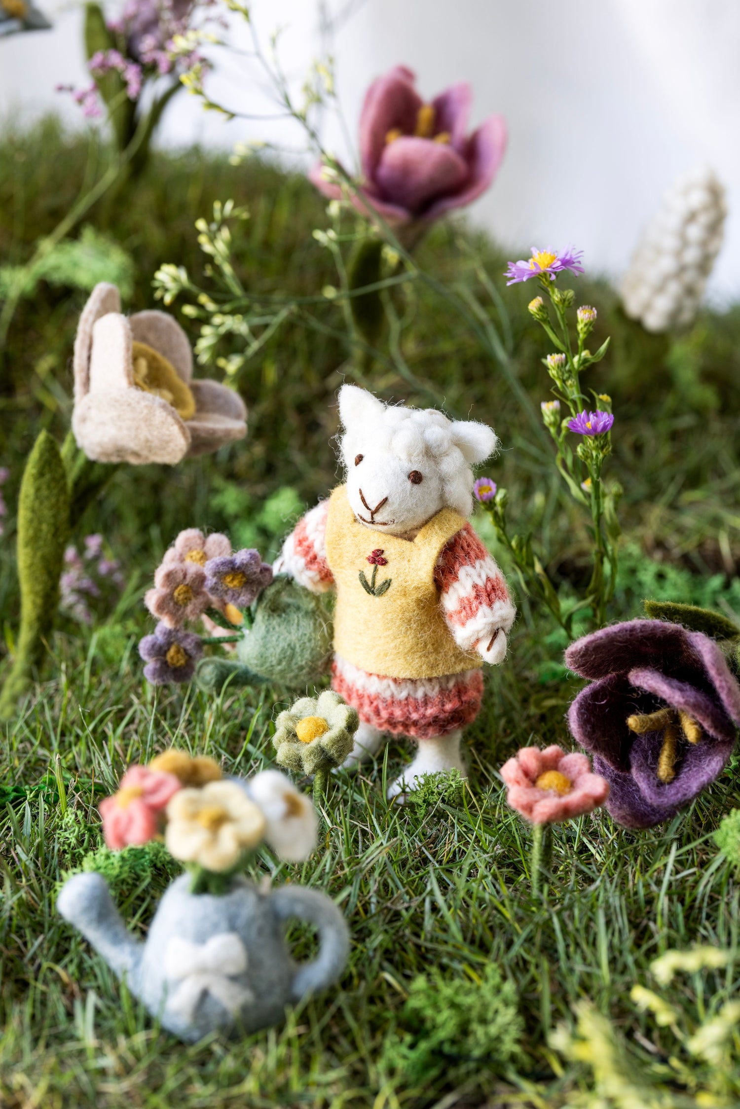 Kleines Schäfchenmädchen mit Gießkanne